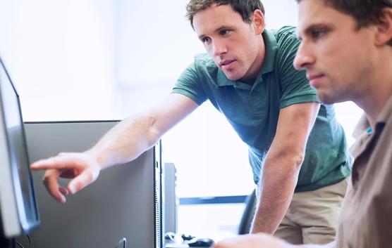 Man Pointing at Computer Screen