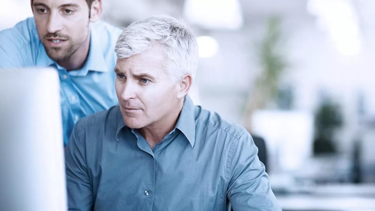 Two Men Looking at Computer Screen