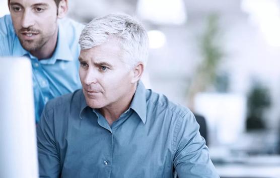 Two Men Looking at Computer Screen