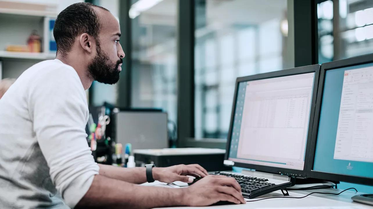 Man Working With Two Monitors
