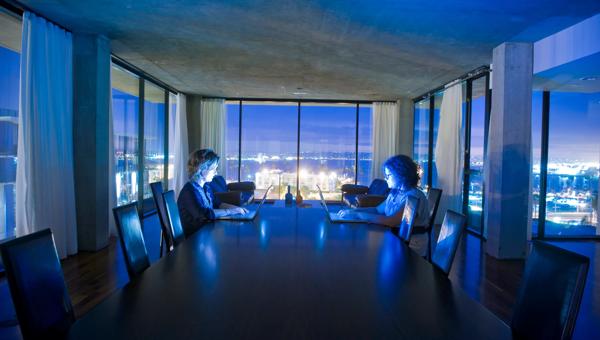 Co-Workers Typing in Conference Room