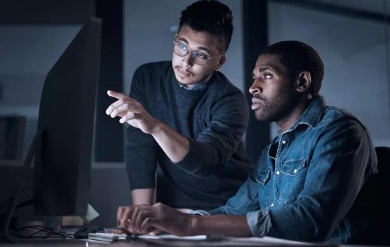 Two Men Working at Night in Office