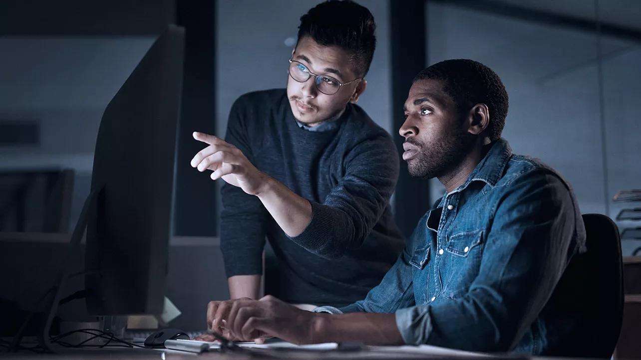 Two Men Working at Night in Office