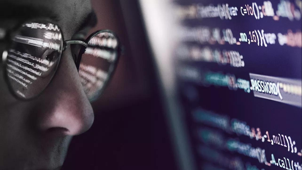 Man With Glasses Looking at Code
