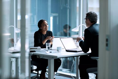 Woman and Man Talking in Office Desk