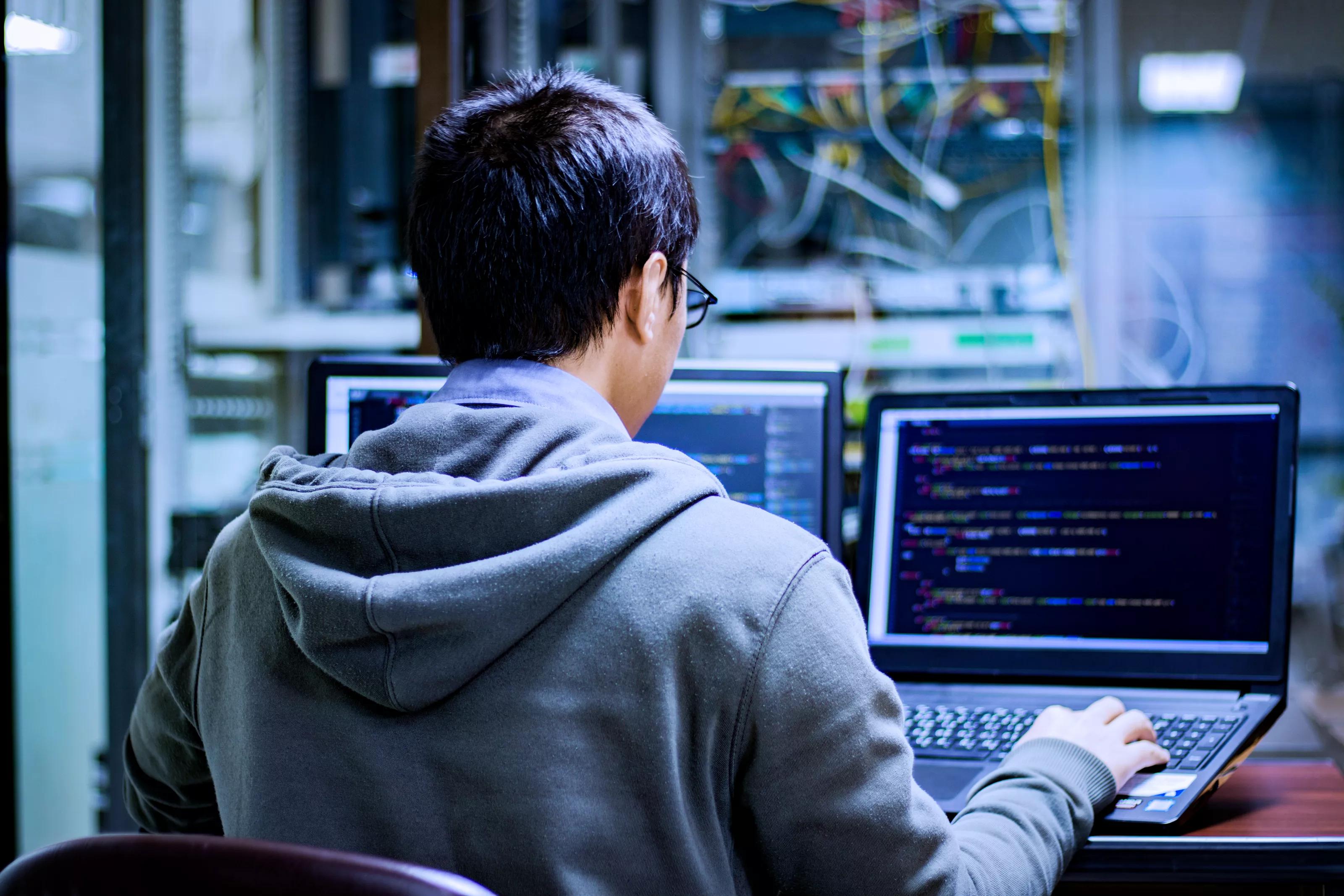 Developer Working on Code in Server Room