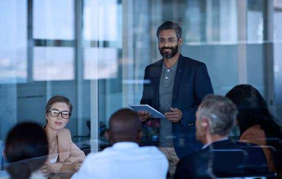 Man Speaking to Group of People at a Conference Room