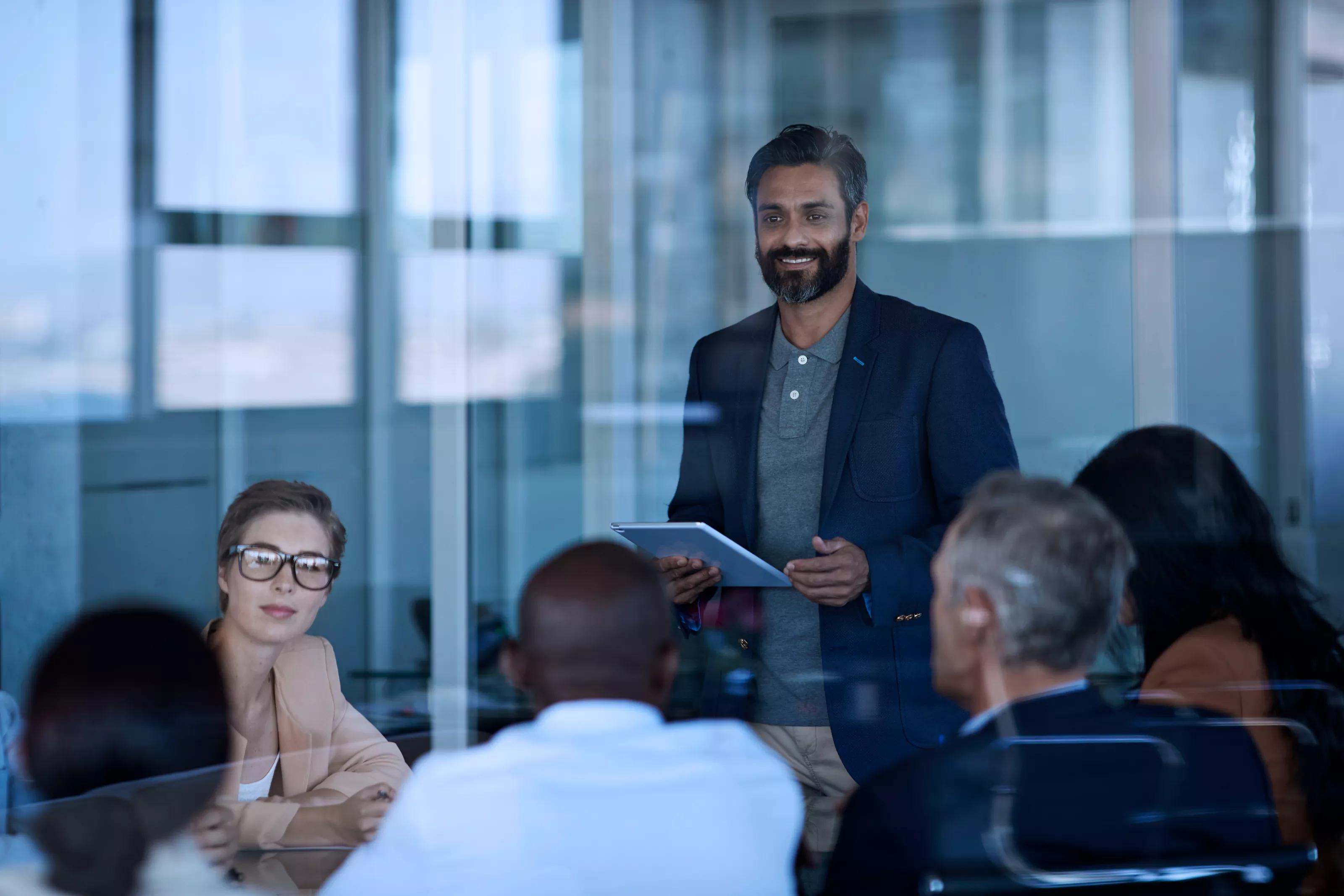 Man Speaking to Group of People at a Conference Room