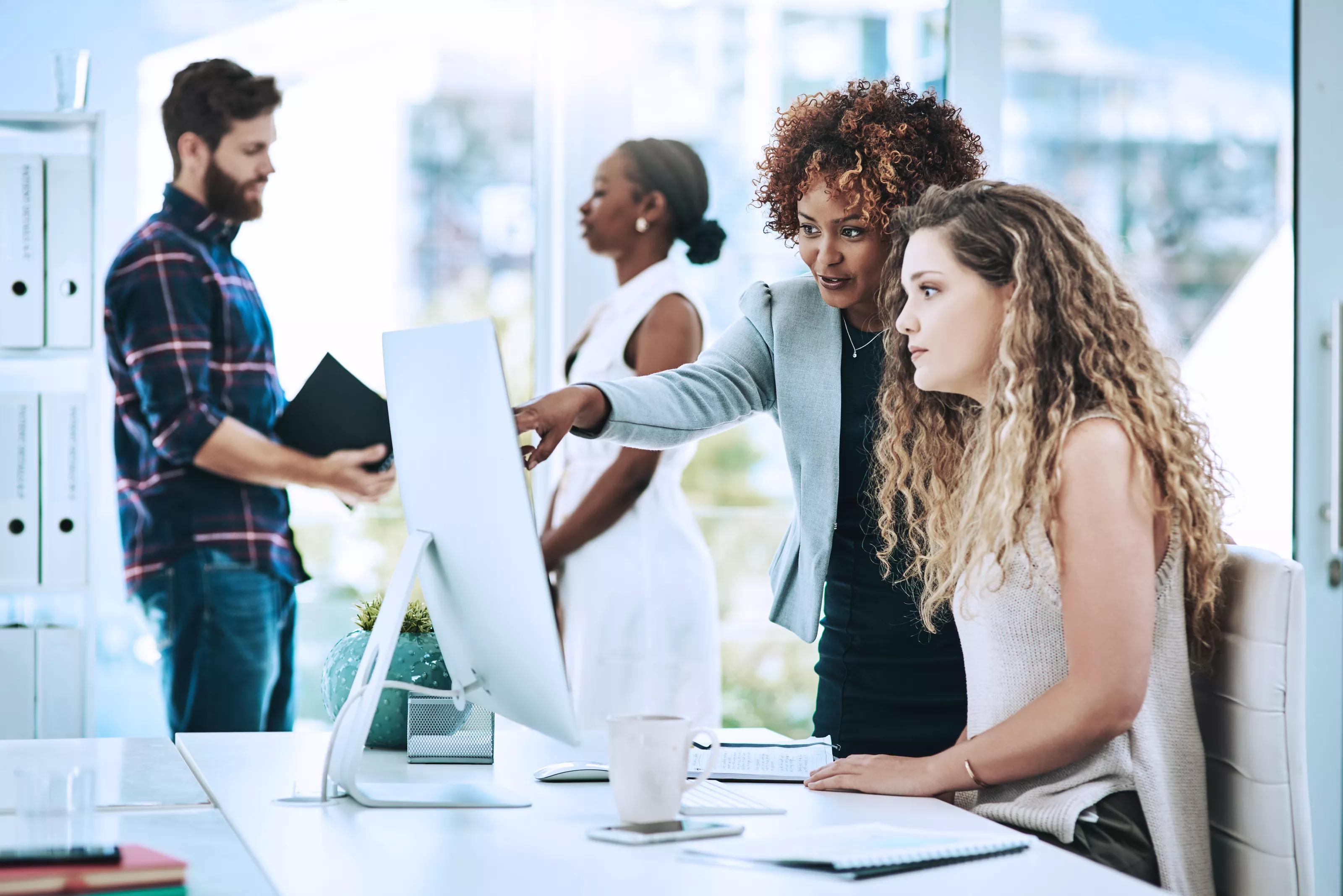 Businesswomen Working Together on a Computer in an Office