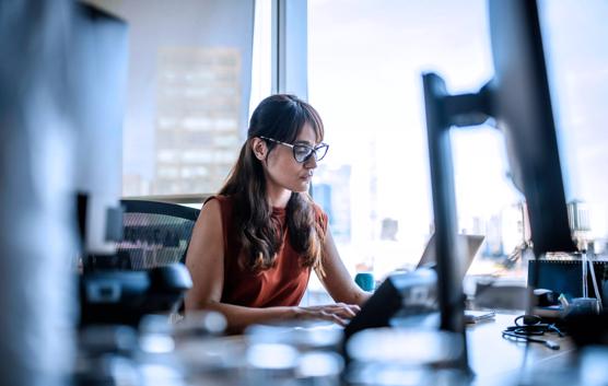 Woman Working in Laptop in Office