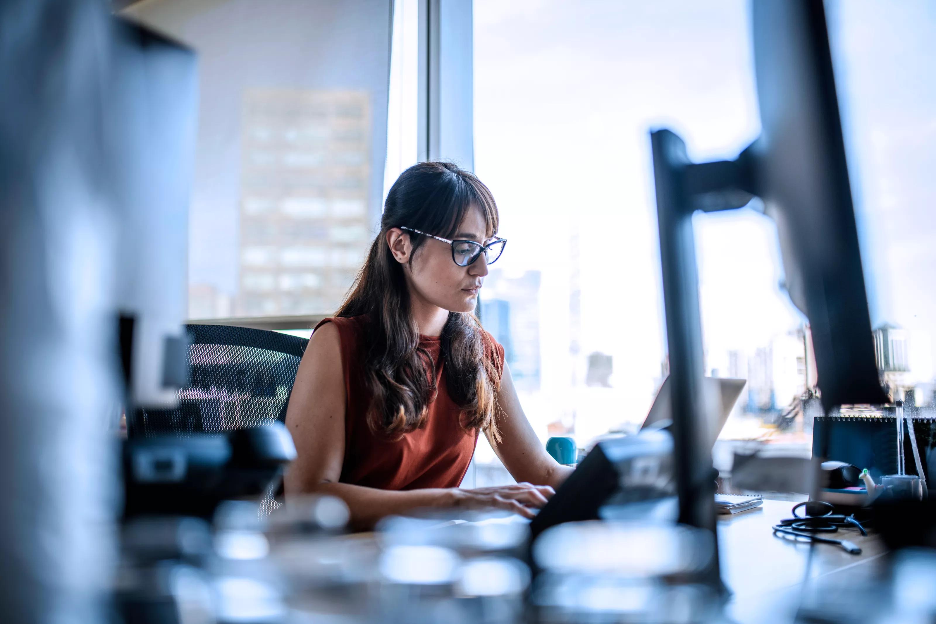 Woman Working in Laptop in Office