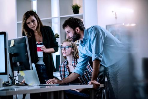 Young coworkers working and discussing work at office