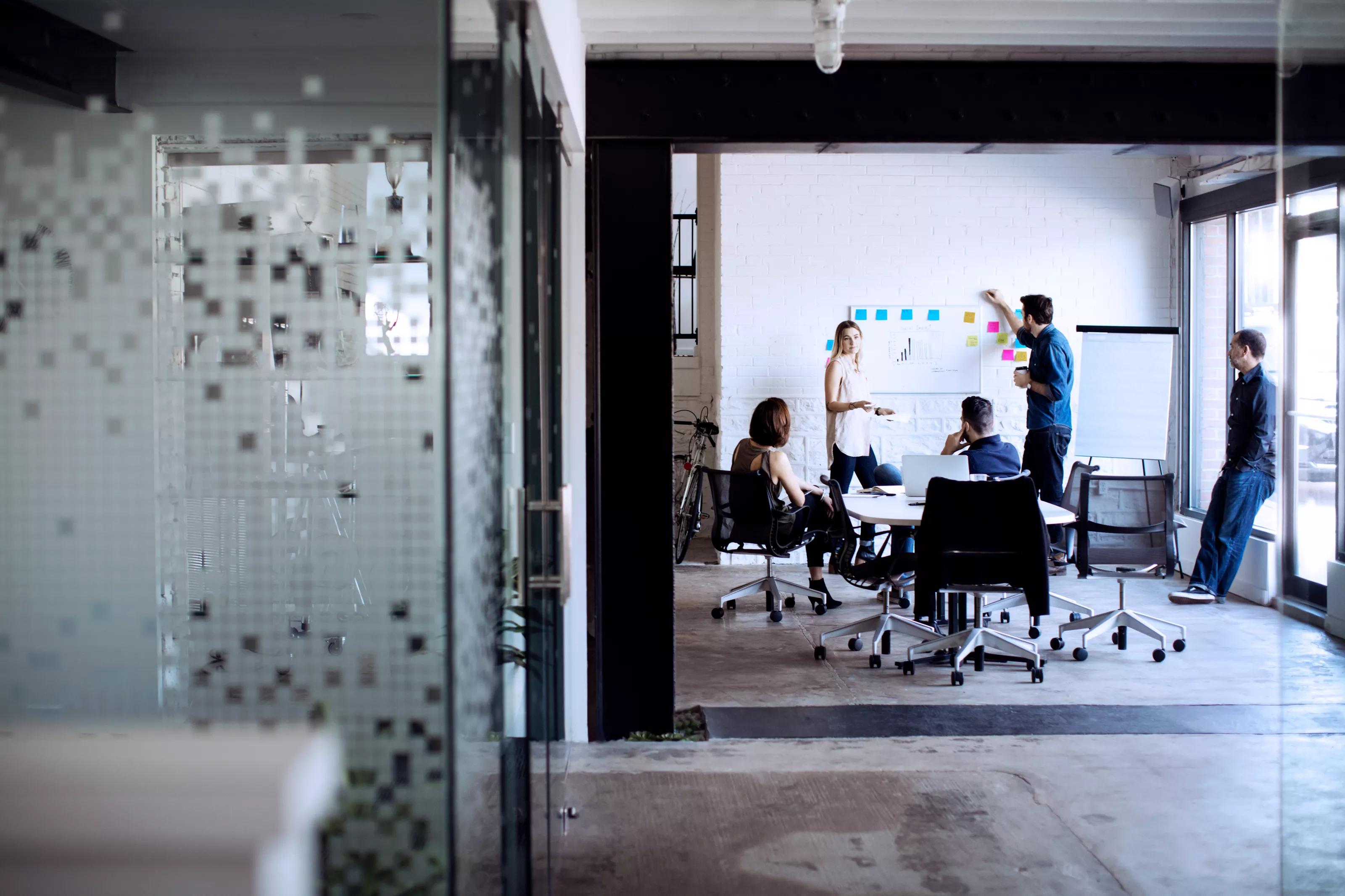 Workers Discussing Business Strategies in Conference Room