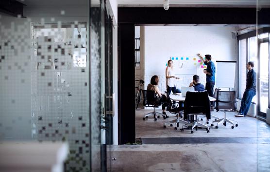 Workers Discussing Business Strategies in Conference Room