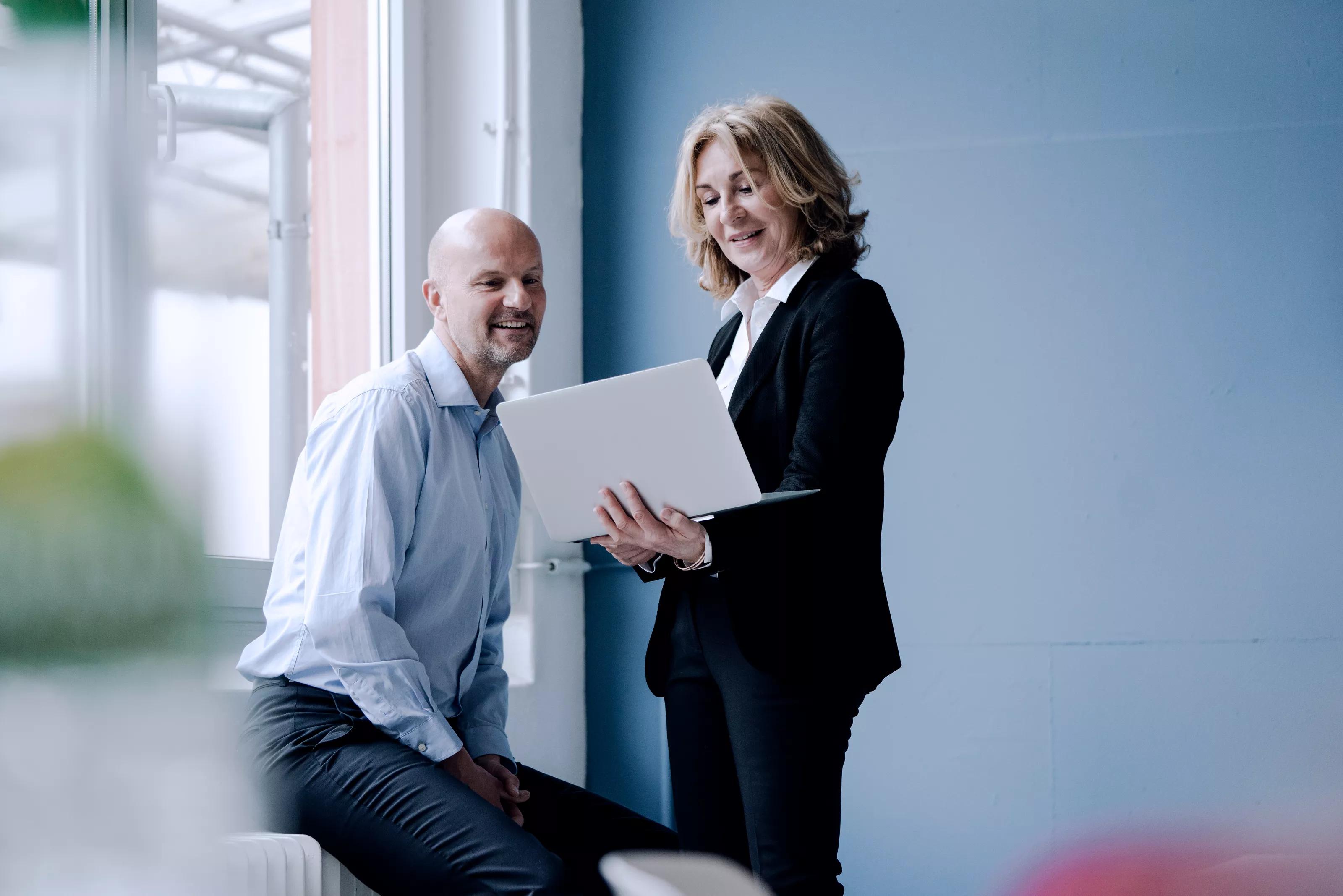 Colleagues Looking at Laptop Screen
