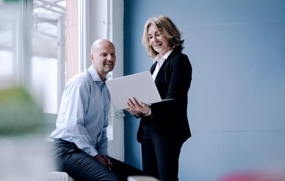 Colleagues Looking at Laptop Screen